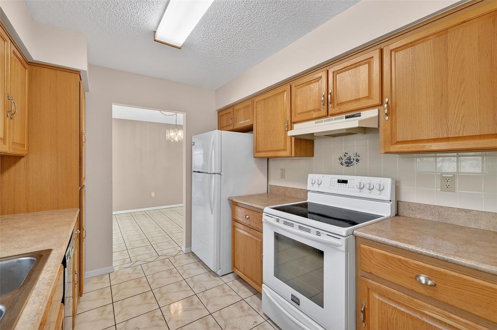 9398 Southeast 174th Loop Summerfield, FL 34491 - Photo 13 of 29 a kitchen with a stove top oven and cabinets