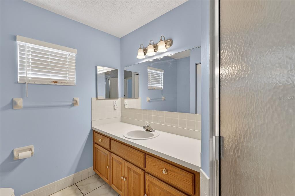 9398 Southeast 174th Loop Summerfield, FL 34491 - Photo 18 of 29 a bathroom with a sink a vanity and a mirror