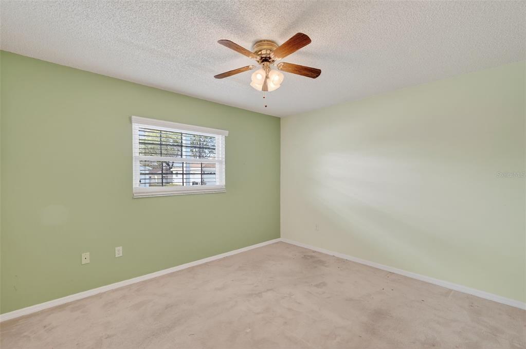 9398 Southeast 174th Loop Summerfield, FL 34491 - Photo 20 of 29 an empty room with window and ceiling fan