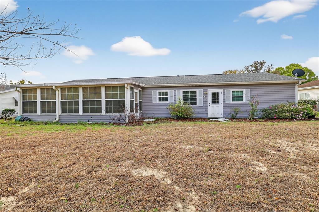 9398 Southeast 174th Loop Summerfield, FL 34491 - Photo 25 of 29 a view of a house with a backyard