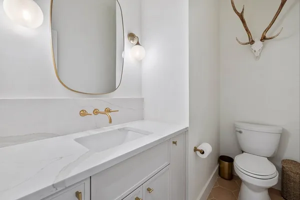 a bedroom with a balcony a bed and a dresser next to a window