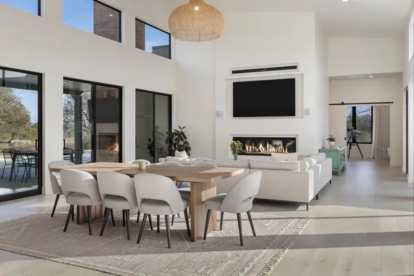 a view of kitchen with stainless steel appliances kitchen island dining table and chairs