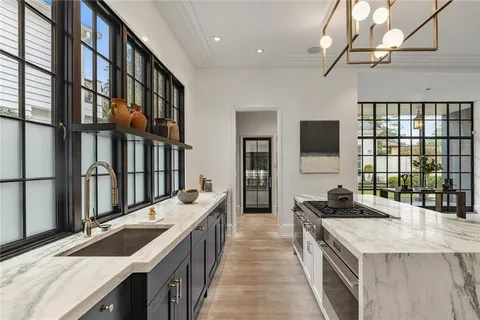 a kitchen with stainless steel appliances granite countertop a sink and a stove
