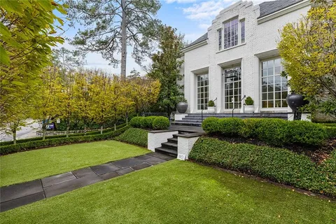 a view of a house with a yard and sitting area