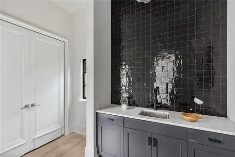 a bathroom with a sink mirror and double