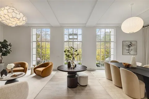 a living room with furniture a table and a large window