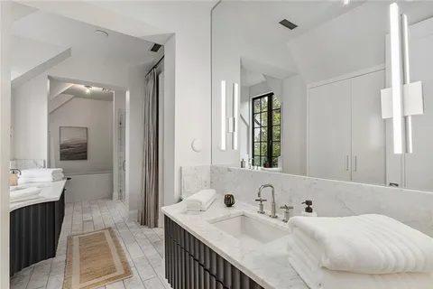 a bathroom with a sink double vanity and a mirror