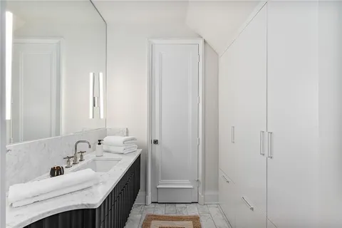 a bathroom with double vanity sink and a mirror