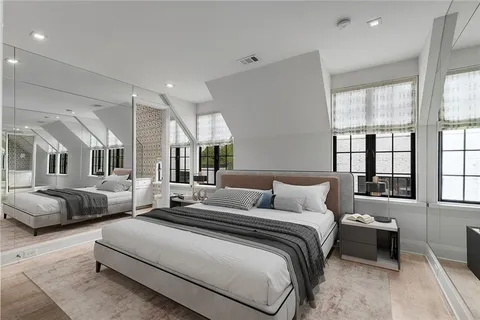 a bedroom with furniture and a large window