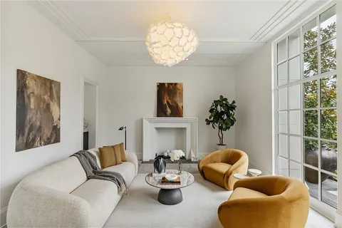 a living room with furniture a chandelier and a large window
