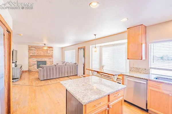 a spacious bathroom with a granite countertop sink and a bathtub