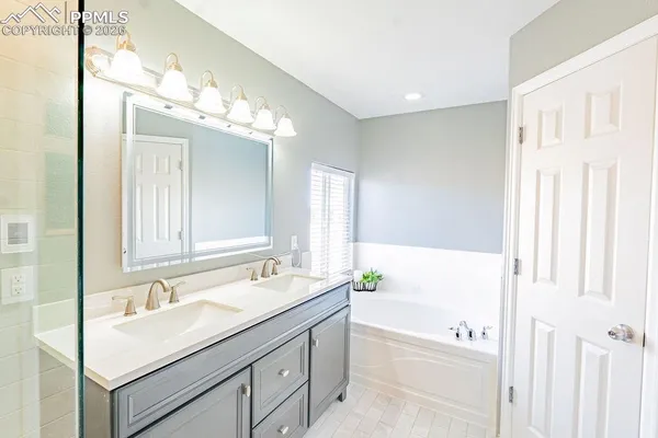 a bathroom with a sink double vanity and a mirror