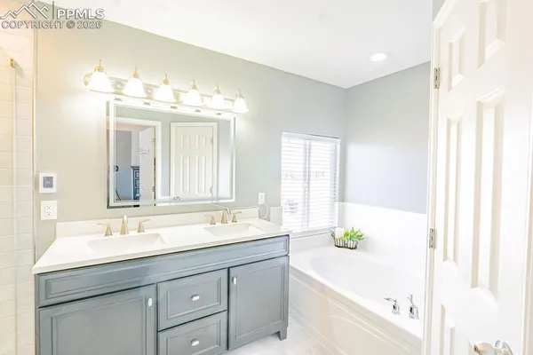 a bathroom with a double vanity sink and a bathtub