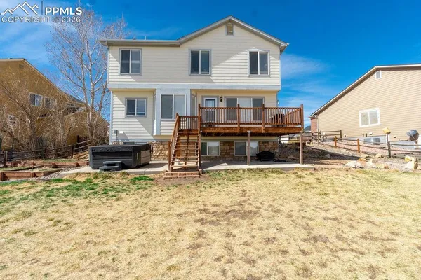 a view of a house with a wooden fence