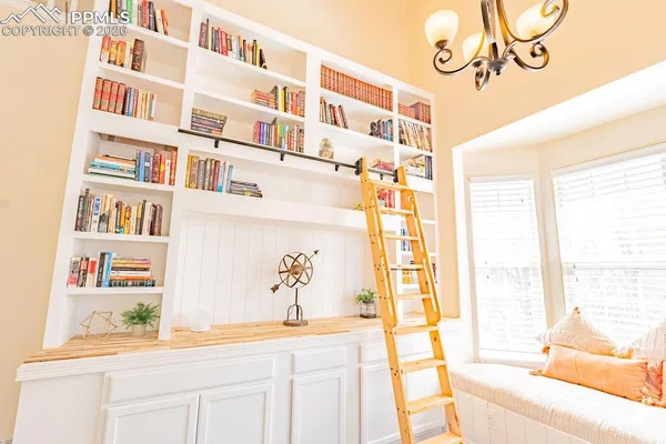 a view of a living room and a window with kitchen area