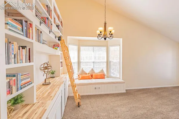 a very nice looking room with a large window and a chandelier