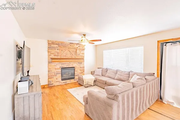 a living room with furniture a fireplace and a flat screen tv