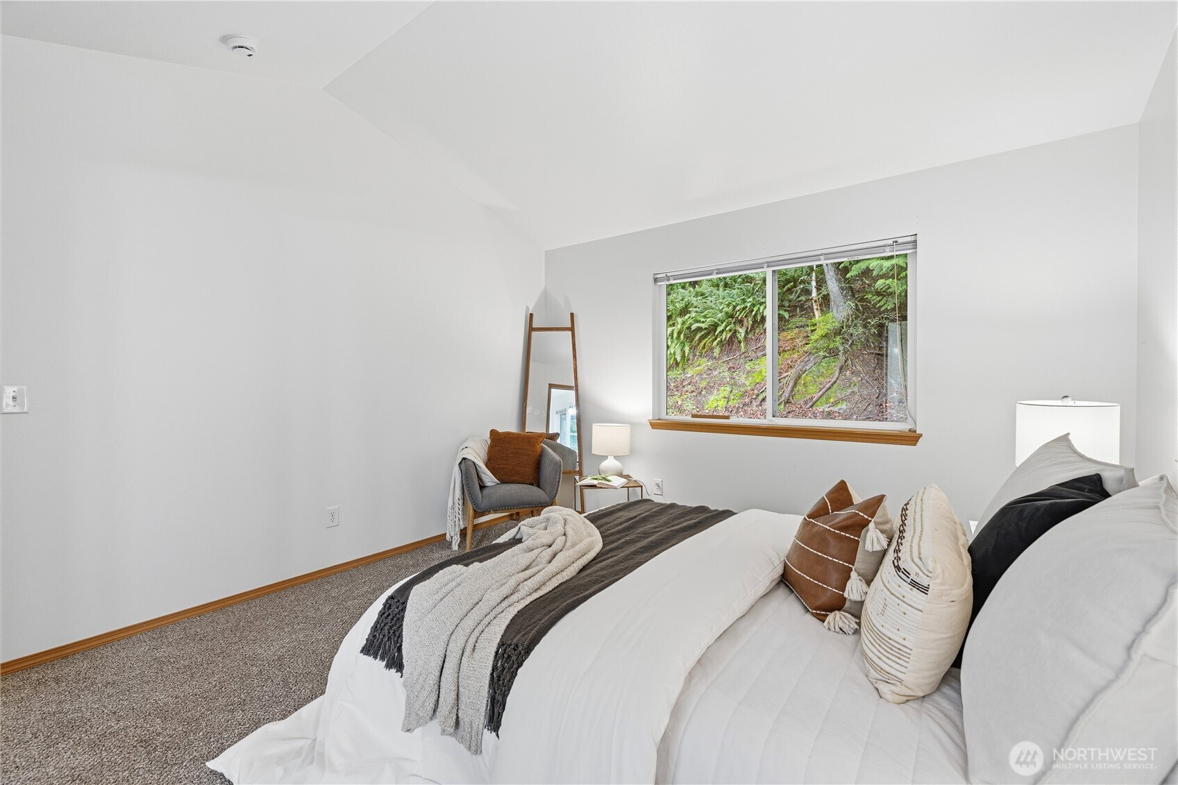 39 Sudden Valley Drive Bellingham, WA 98229 - Photo 12 of 40 a bedroom with a bed and wooden floor