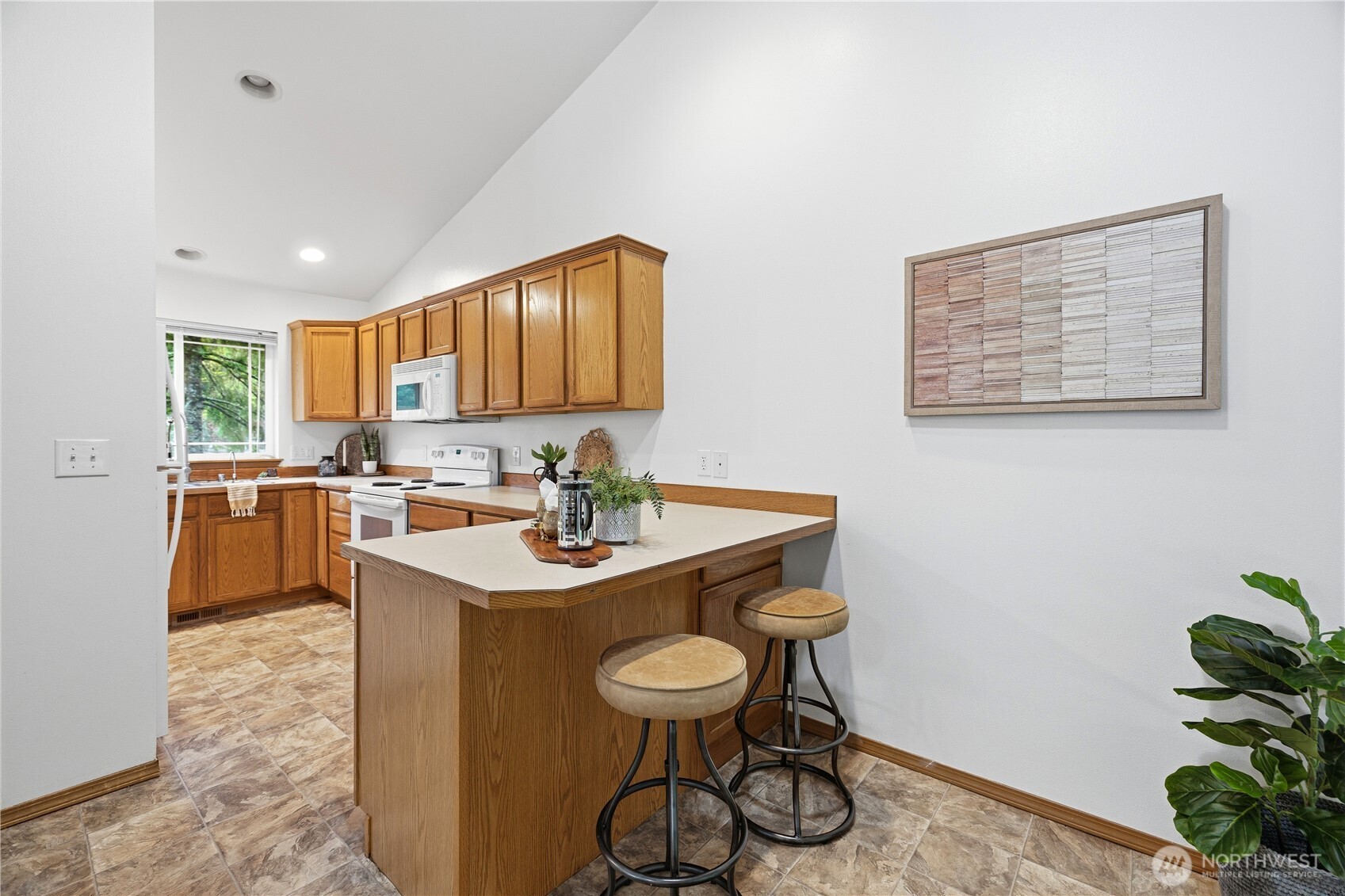 39 Sudden Valley Drive Bellingham, WA 98229 - Photo 6 of 40 a kitchen with stainless steel appliances granite countertop a sink a stove a dining table and chairs with wooden floor