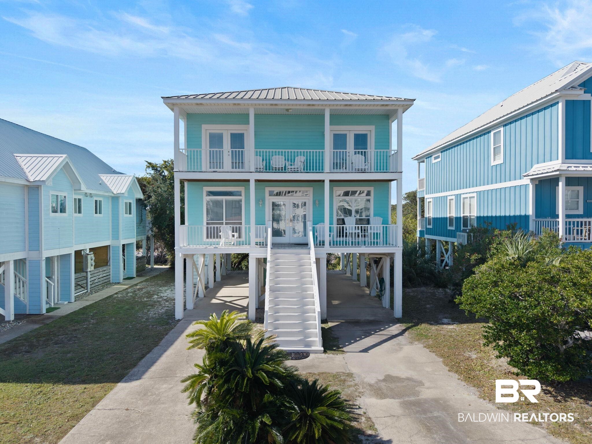 545 Plantation Road, Unit 3 Gulf Shores, AL 36542 - Photo 1 of 54 Raised beach house featuring french doors, a carport, concrete driveway, and a metal roof