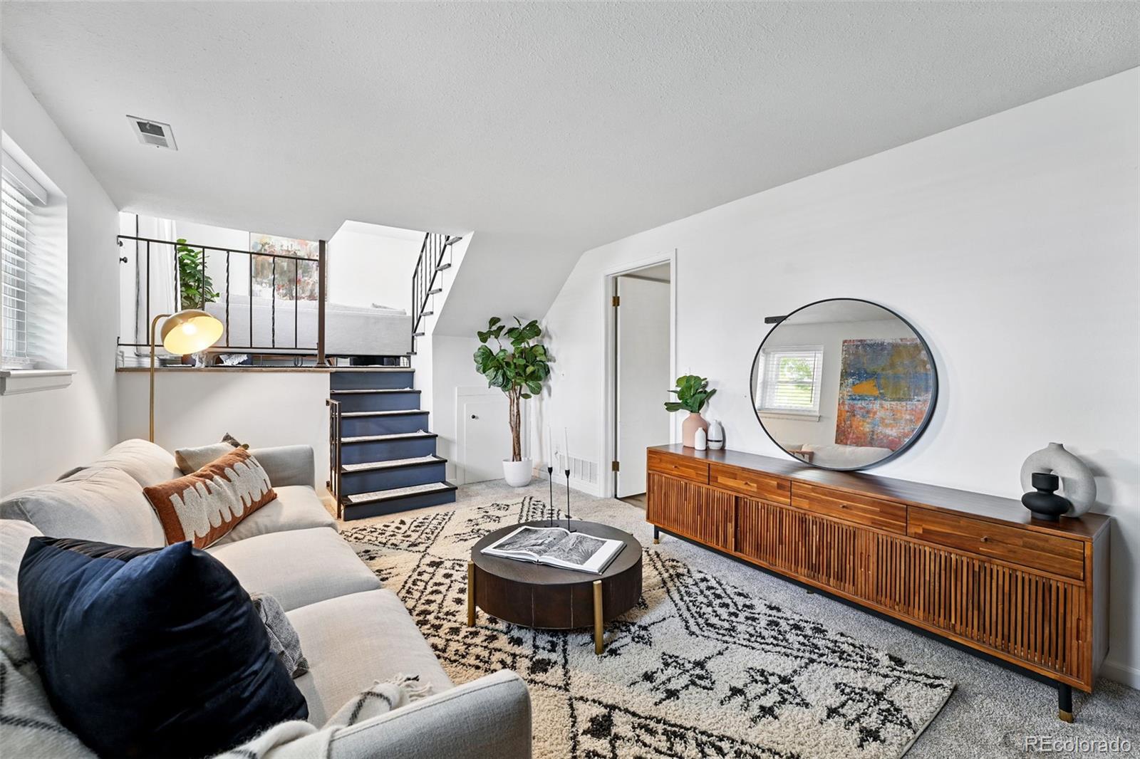 9315 Field Lane Westminster, CO 80021 - Photo 17 of 50 a living room with furniture a mirror and a large window