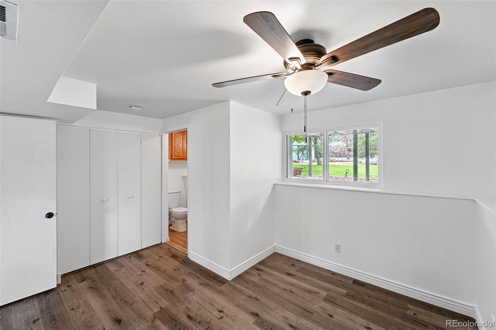 9315 Field Lane Westminster, CO 80021 - Photo 18 of 50 wooden floor in an empty room with a window