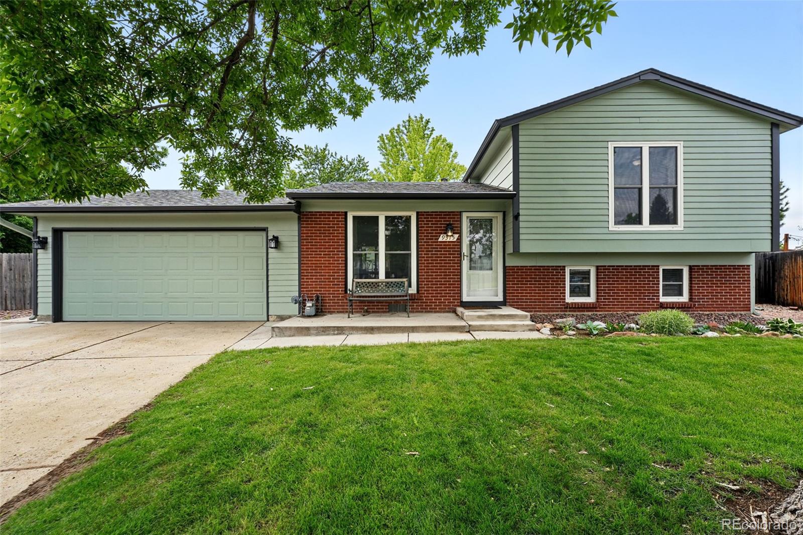 9315 Field Lane Westminster, CO 80021 - Photo 2 of 50 a front view of a house with a garden