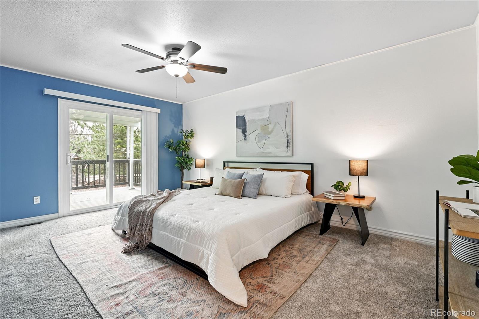 9315 Field Lane Westminster, CO 80021 - Photo 22 of 50 a bedroom with a large bed and a chandelier