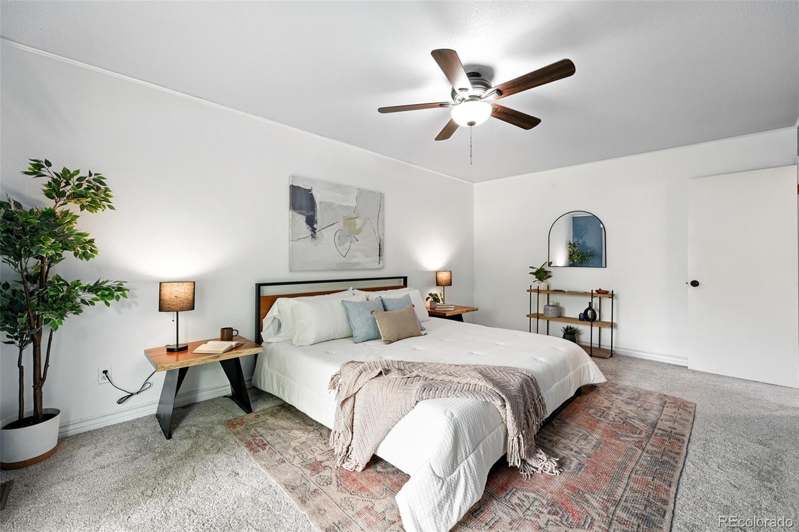 9315 Field Lane Westminster, CO 80021 - Photo 23 of 50 a bed room with a bed and a potted plant