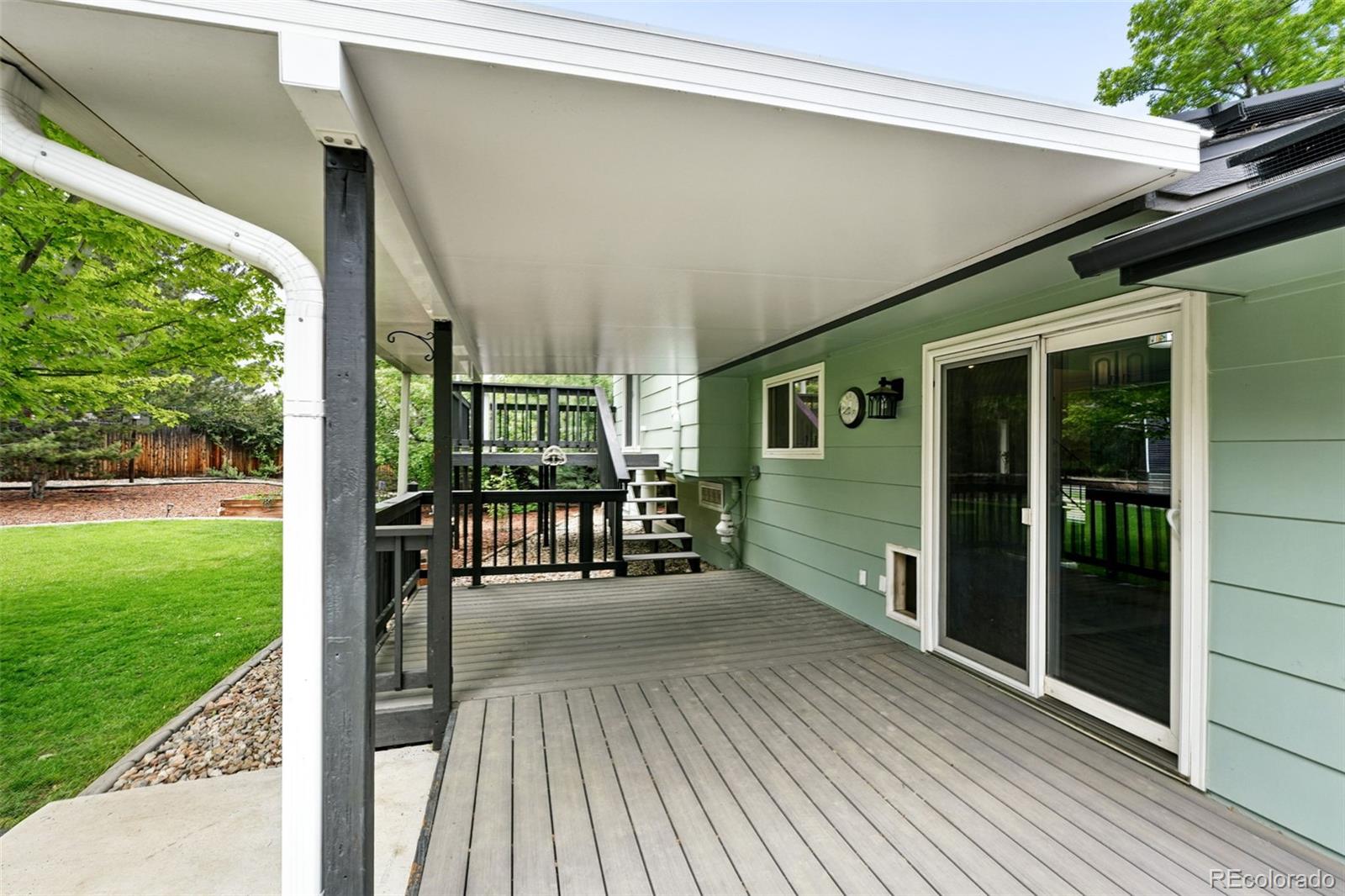 9315 Field Lane Westminster, CO 80021 - Photo 28 of 50 a view of a porch with chairs and backyard