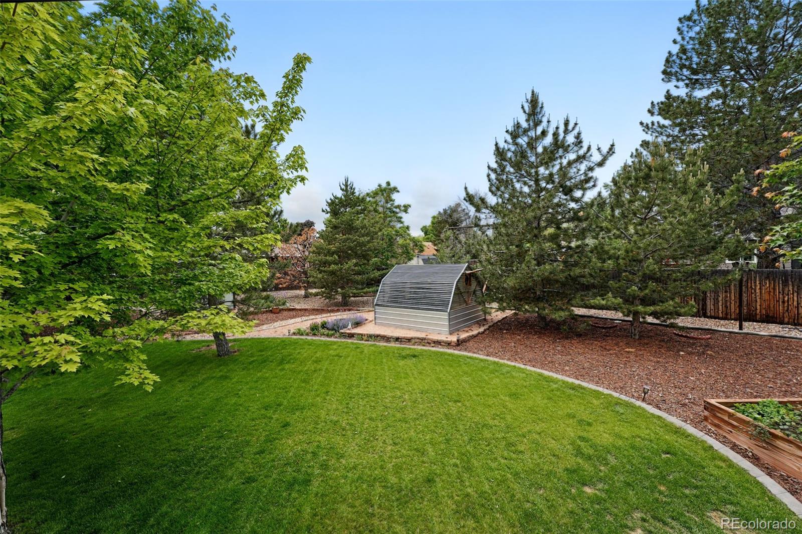 9315 Field Lane Westminster, CO 80021 - Photo 36 of 50 a view of a chair and table in the garden
