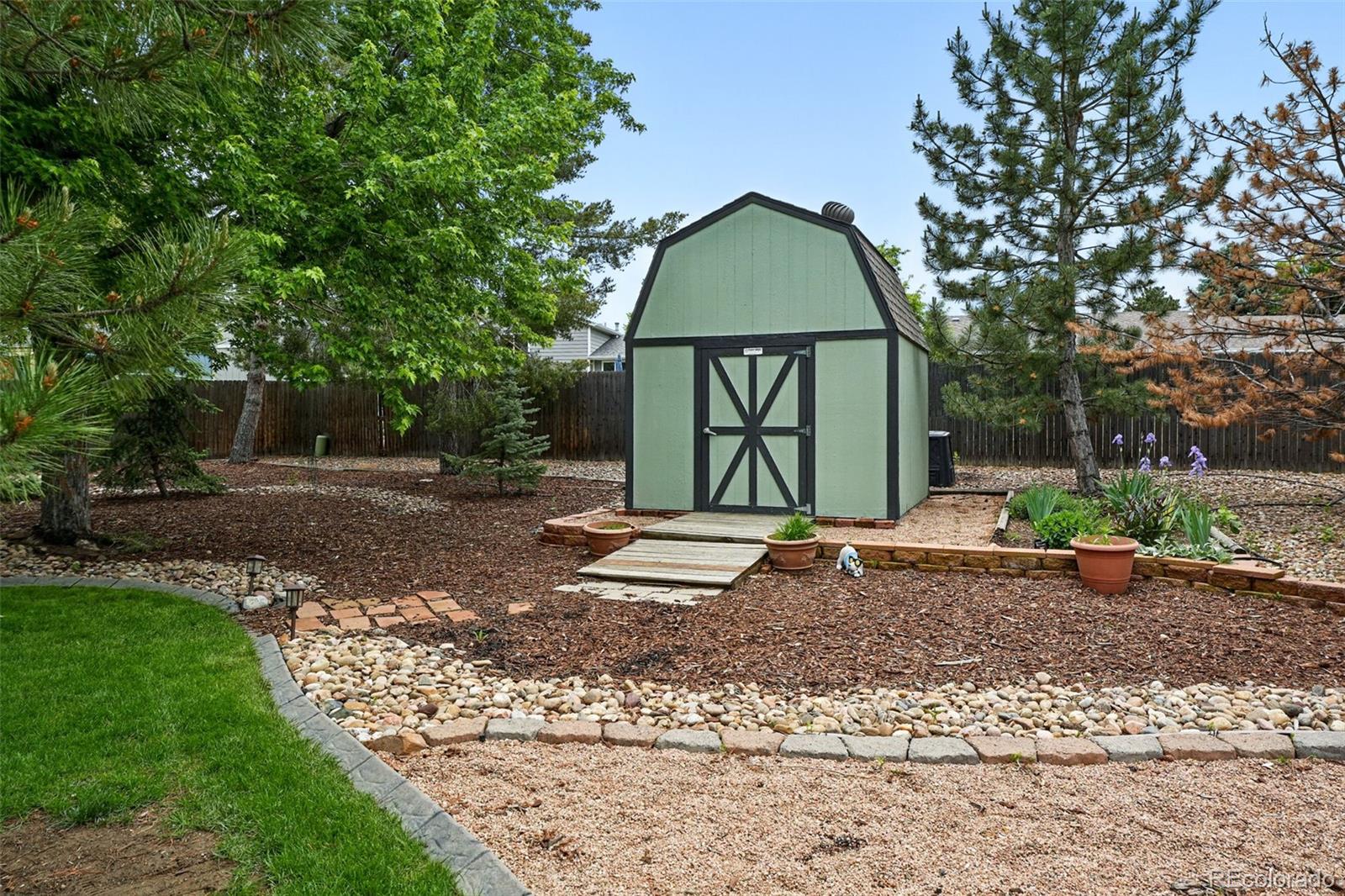 9315 Field Lane Westminster, CO 80021 - Photo 38 of 50 a view of a brick house with a yard