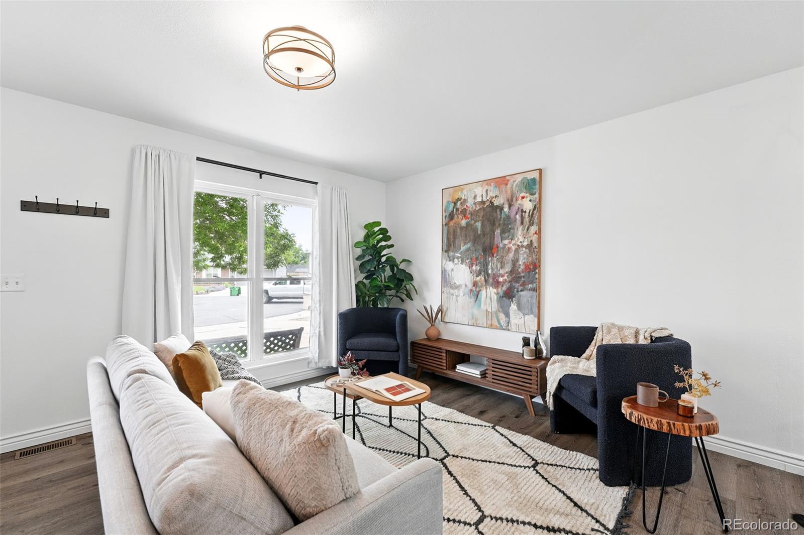 9315 Field Lane Westminster, CO 80021 - Photo 5 of 50 a living room with furniture and a window