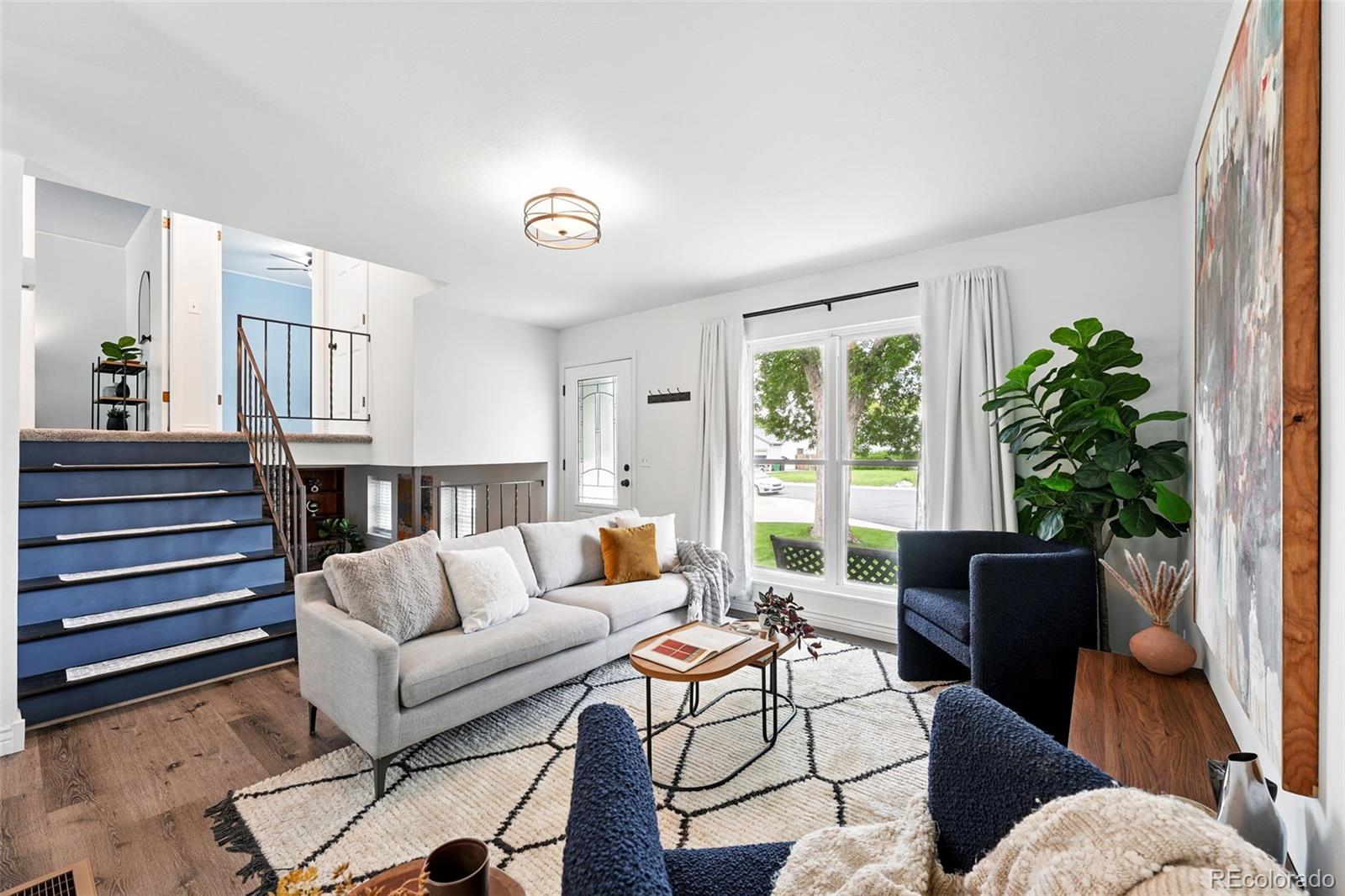 9315 Field Lane Westminster, CO 80021 - Photo 7 of 50 a living room with furniture fireplace and potted plants