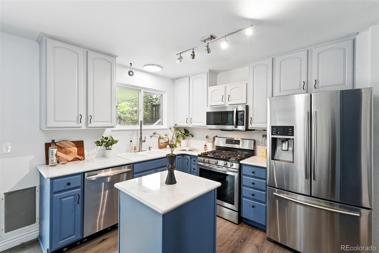 9315 Field Lane Westminster, CO 80021 - Photo 10 of 50 a kitchen with stainless steel appliances a refrigerator sink and microwave