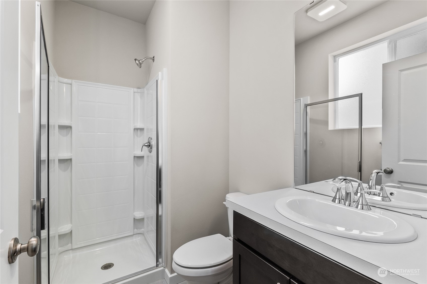 23413 Edmonds Way, Unit E1 Edmonds, WA 98026 - Photo 13 of 27 a bathroom with a sink a toilet and shower