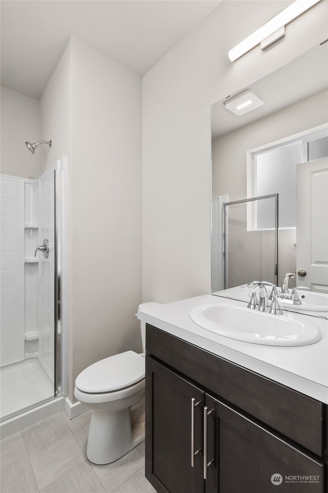 23413 Edmonds Way, Unit E1 Edmonds, WA 98026 - Photo 14 of 27 a bathroom with a sink a toilet and shower
