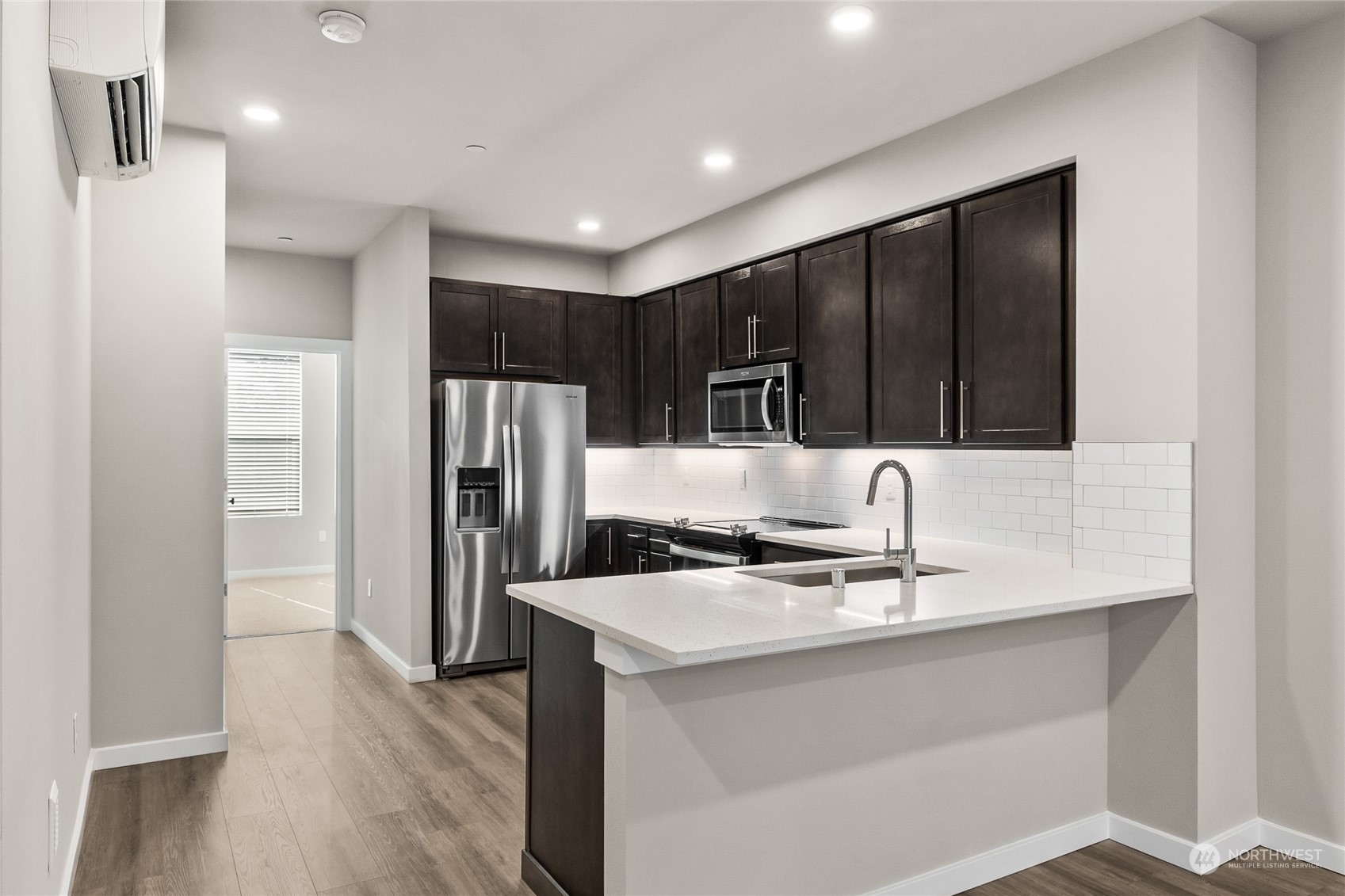 23413 Edmonds Way, Unit E1 Edmonds, WA 98026 - Photo 7 of 27 a kitchen with kitchen island a sink appliances and cabinets