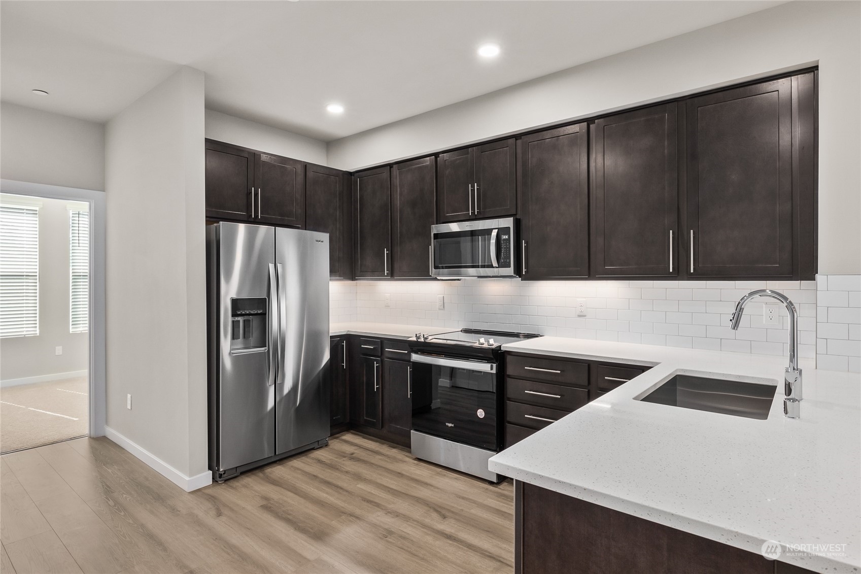 23413 Edmonds Way, Unit E1 Edmonds, WA 98026 - Photo 8 of 27 a kitchen with granite countertop a refrigerator and a sink