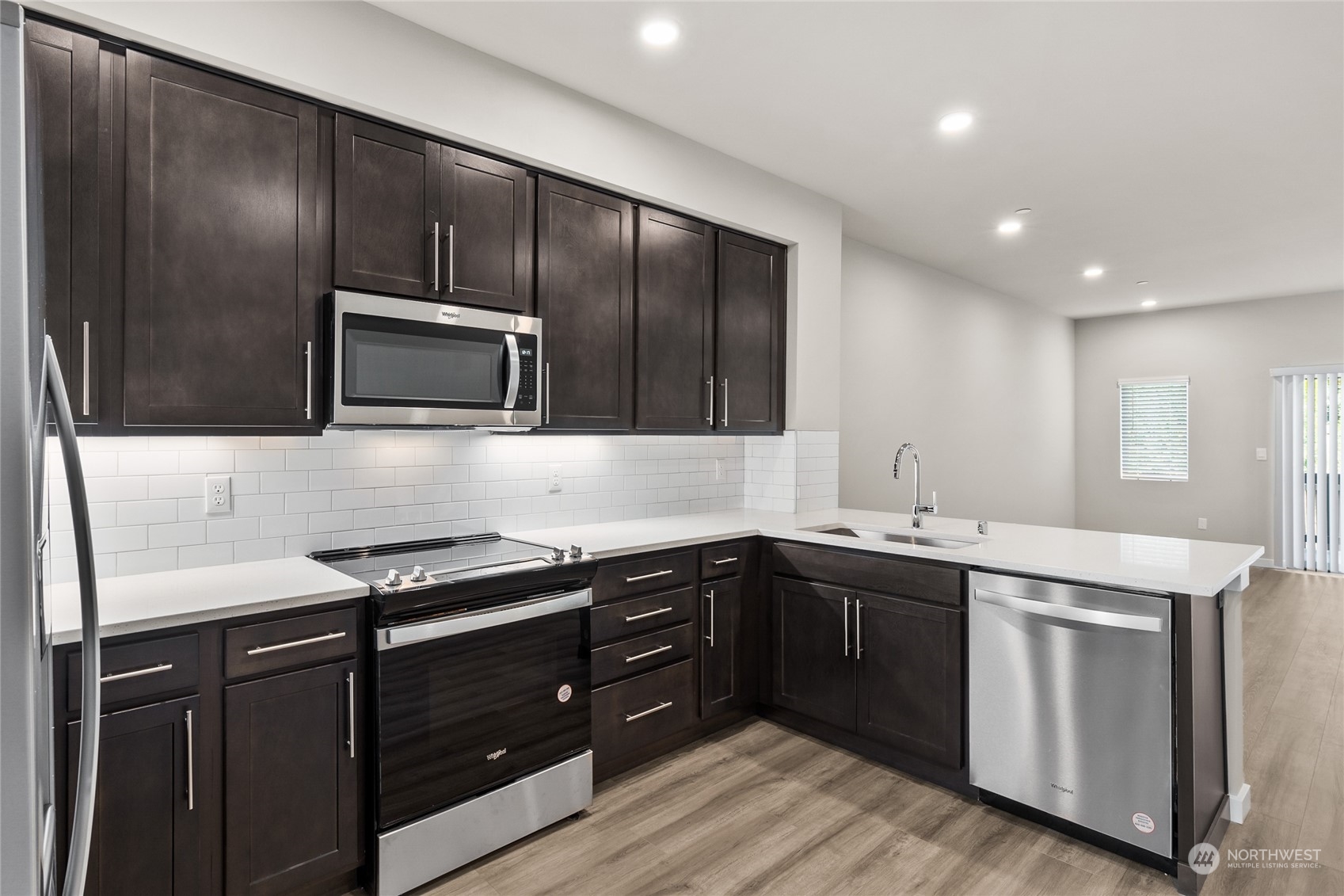 23413 Edmonds Way, Unit E1 Edmonds, WA 98026 - Photo 9 of 27 a kitchen with a sink and stainless steel appliances