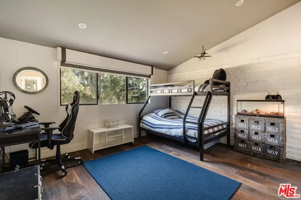 a bedroom with bed and a large window