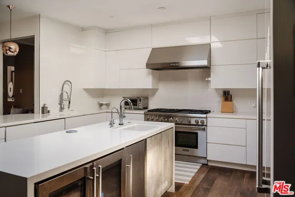 a kitchen with a stove a sink and a refrigerator