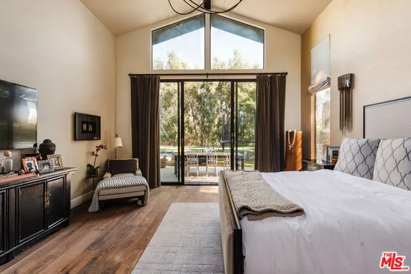 a bed room with a bed and a large window