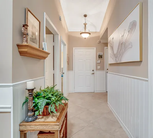 a view of entryway with paintings on the wall