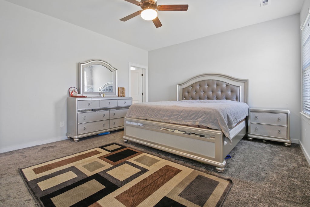 917 Plowson Road Mount Juliet, TN 37122 - Photo 17 of 47 a bedroom with a bed and a chandelier