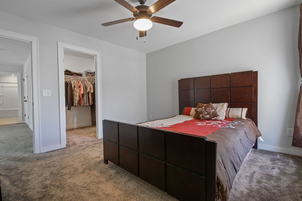 917 Plowson Road Mount Juliet, TN 37122 - Photo 25 of 47 a bedroom with a bed and a chandelier