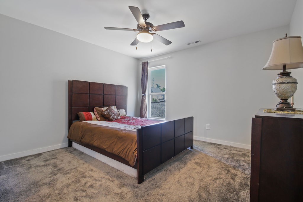 917 Plowson Road Mount Juliet, TN 37122 - Photo 26 of 47 a bed room with a bed and a ceiling fan
