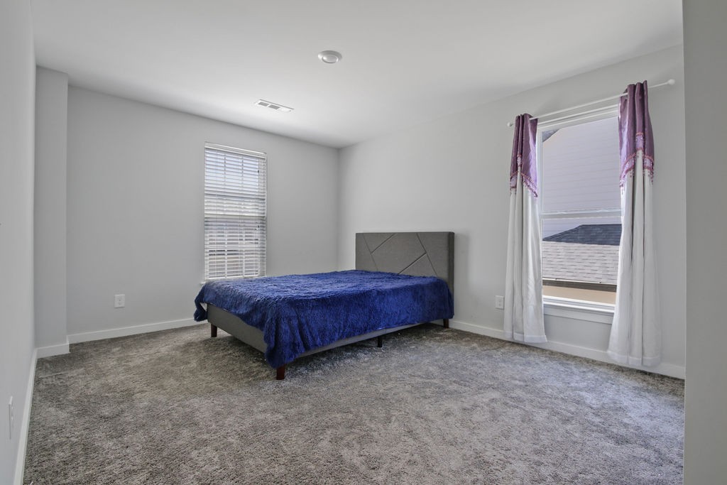 917 Plowson Road Mount Juliet, TN 37122 - Photo 30 of 47 a spacious bedroom with a bed and a window
