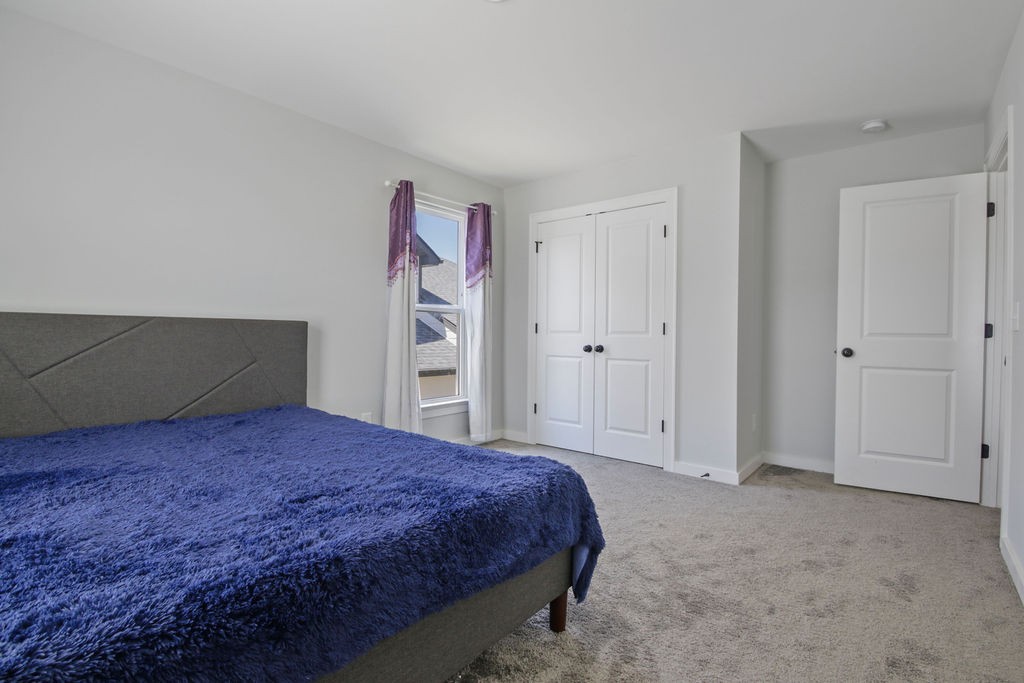 917 Plowson Road Mount Juliet, TN 37122 - Photo 31 of 47 a bedroom with a bed and closet