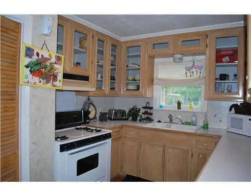 a kitchen with stainless steel appliances a stove a sink and a microwave